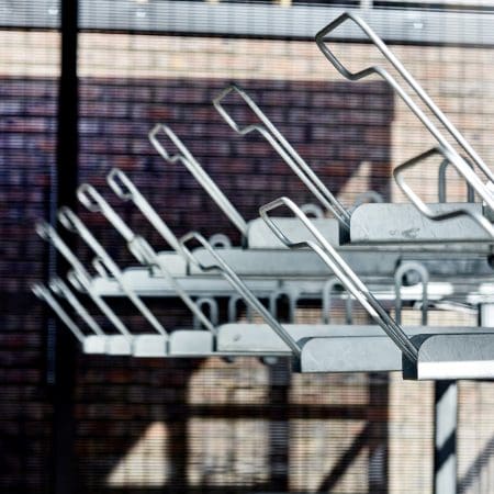 two-tier cycle racks installed within a secure mesh bike storage shelter