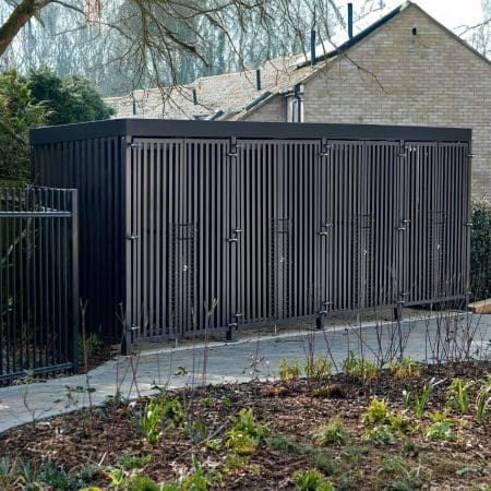 Greenwich Cycle Enclosure with wood cladding in RAL black installed at a residential property