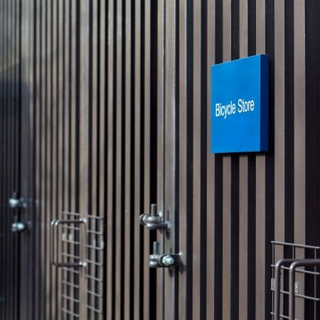 Greenwich Cycle Enclosure with wood cladding in RAL black installed at a residential property
