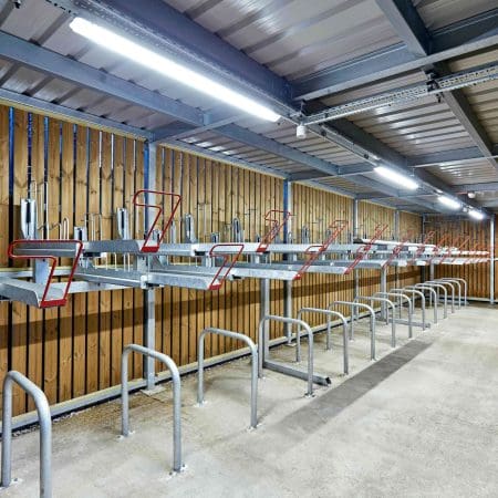 Gas Assisted Two Tier Cycle Racks with Sheffield Stand Lowers installed in a Wooden Cycle Storage Unit with Lighting Installed