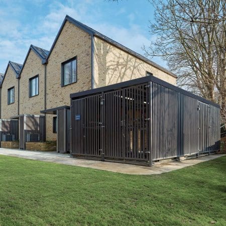 Greenwich Cycle Enclosure with wood cladding in RAL black installed at a residential property