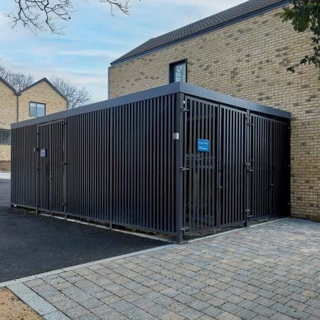 Greenwich Cycle Enclosure with wood cladding in RAL black installed at a residential property