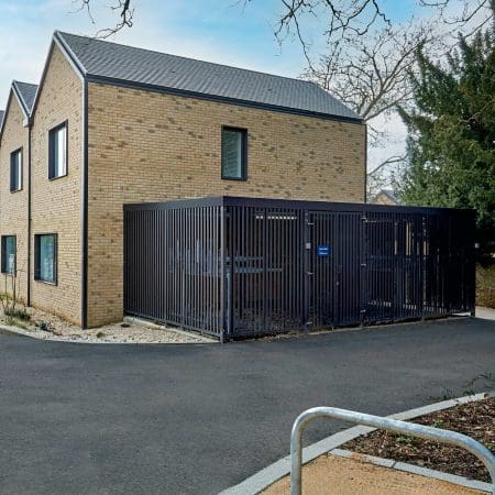 Greenwich Cycle Enclosure with wood cladding in RAL black installed at a residential property