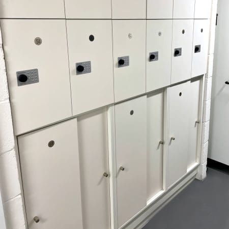Close up shot of the Hackney Accessible Lockers in white installed in an underground cycle storage end of trip facility