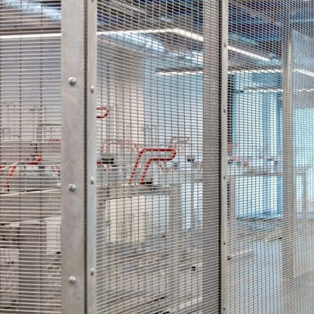 Close up of the two tier bike racks enclosed by the anti-climb mesh fencing.