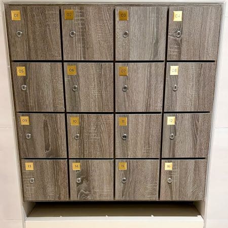 close up of Islington Locker with wood panelling and gold accents installed in an end of trip cycle storage facility