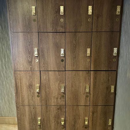 Islington Locker with wood panelling and gold accents installed in an end of trip cycle storage facility