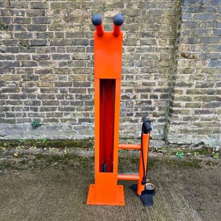 Public Maintenance Bike Stand in RAL colour orange installed outside of a commercial property with a bike pump and various bike repair tools