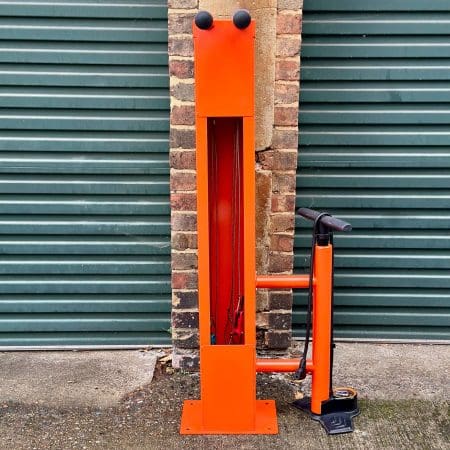 Public Maintenance Bike Stand in RAL colour orange installed outside of a commercial property with a bike pump and various bike repair tools