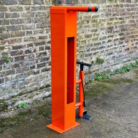 Public Maintenance Bike Stand in RAL colour orange installed outside of a commercial property with a bike pump and various bike repair tools