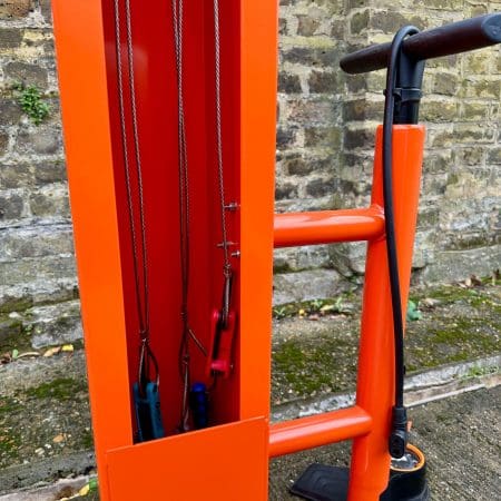 Public Maintenance Bike Stand in RAL colour orange installed outside of a commercial property with a bike pump and various bike repair tools