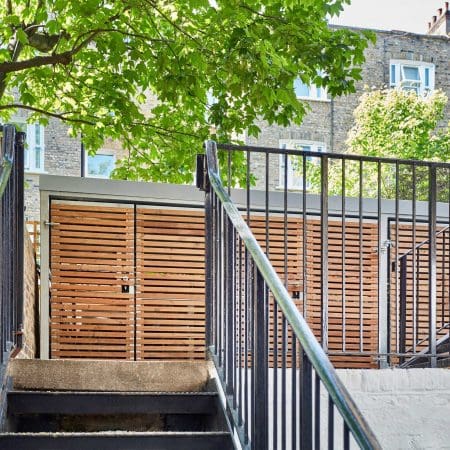 Wooden cycle and bin storage facility with sedum roofing outside