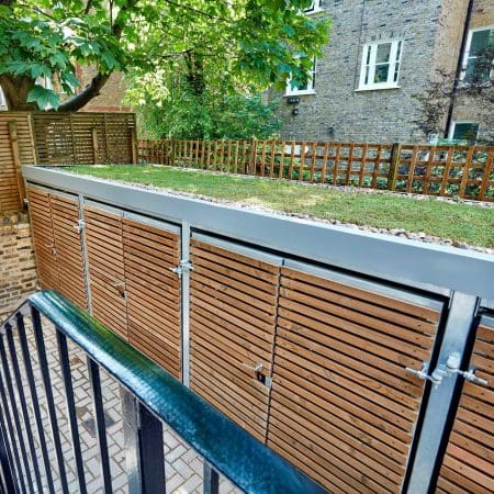 Wooden cycle and bin storage facility with sedum roofing outside