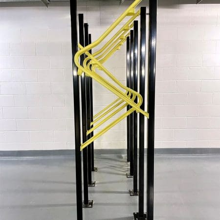 Premium Solo Vertical Bike Rack powder-coated in RAL yellow installed in underground storage facility
