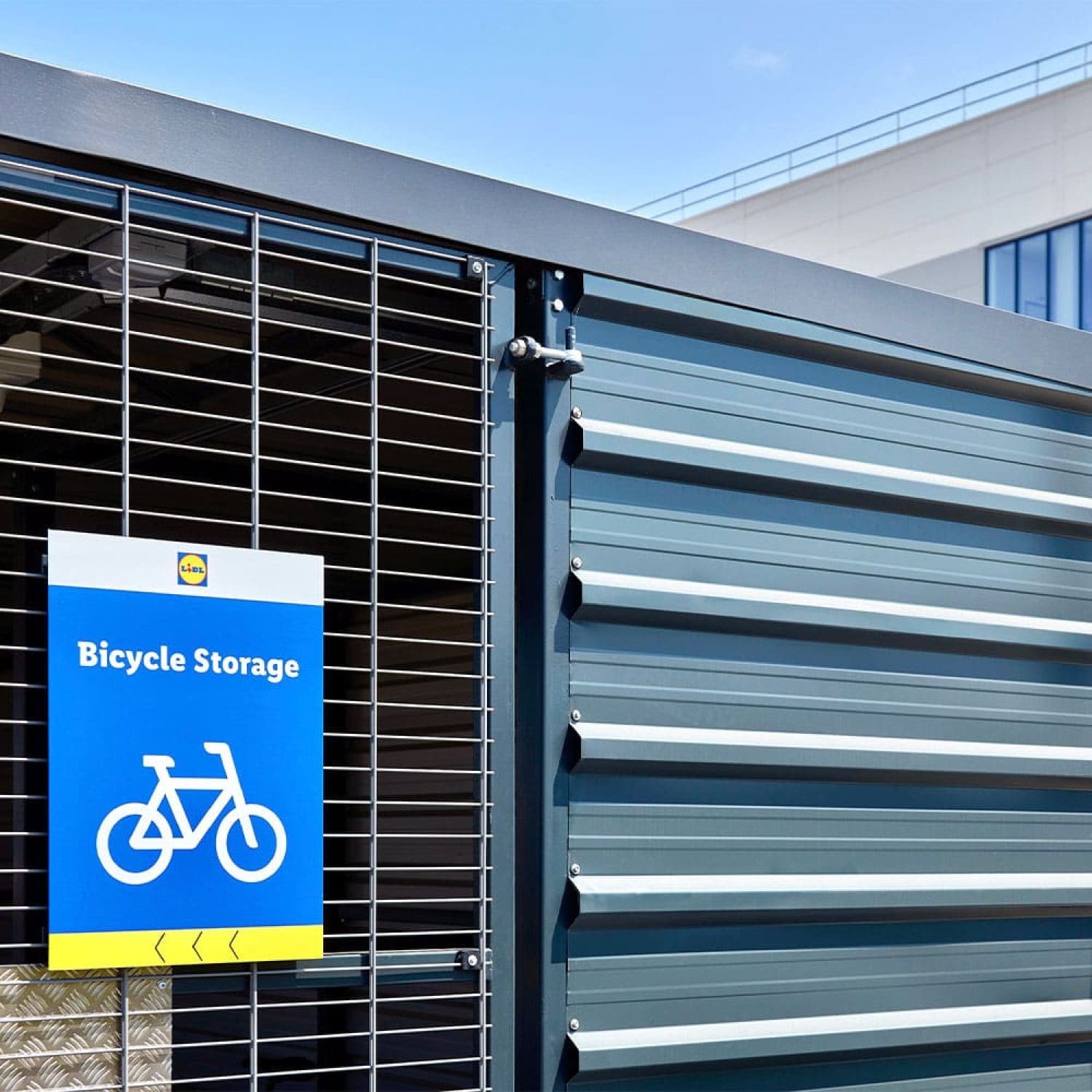 a blue and white cycle storage sign on a metal fence