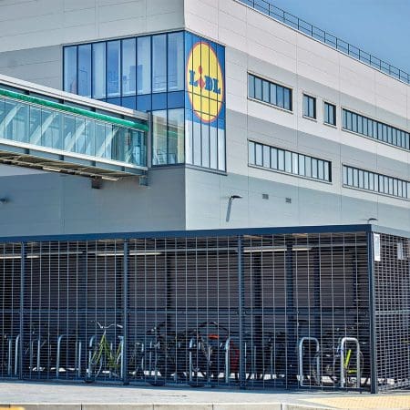 a premium bicycle shed with covered racks outside of a building