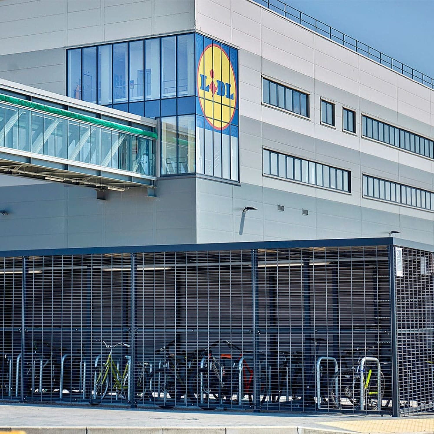 a premium bicycle shed with covered racks outside of a building