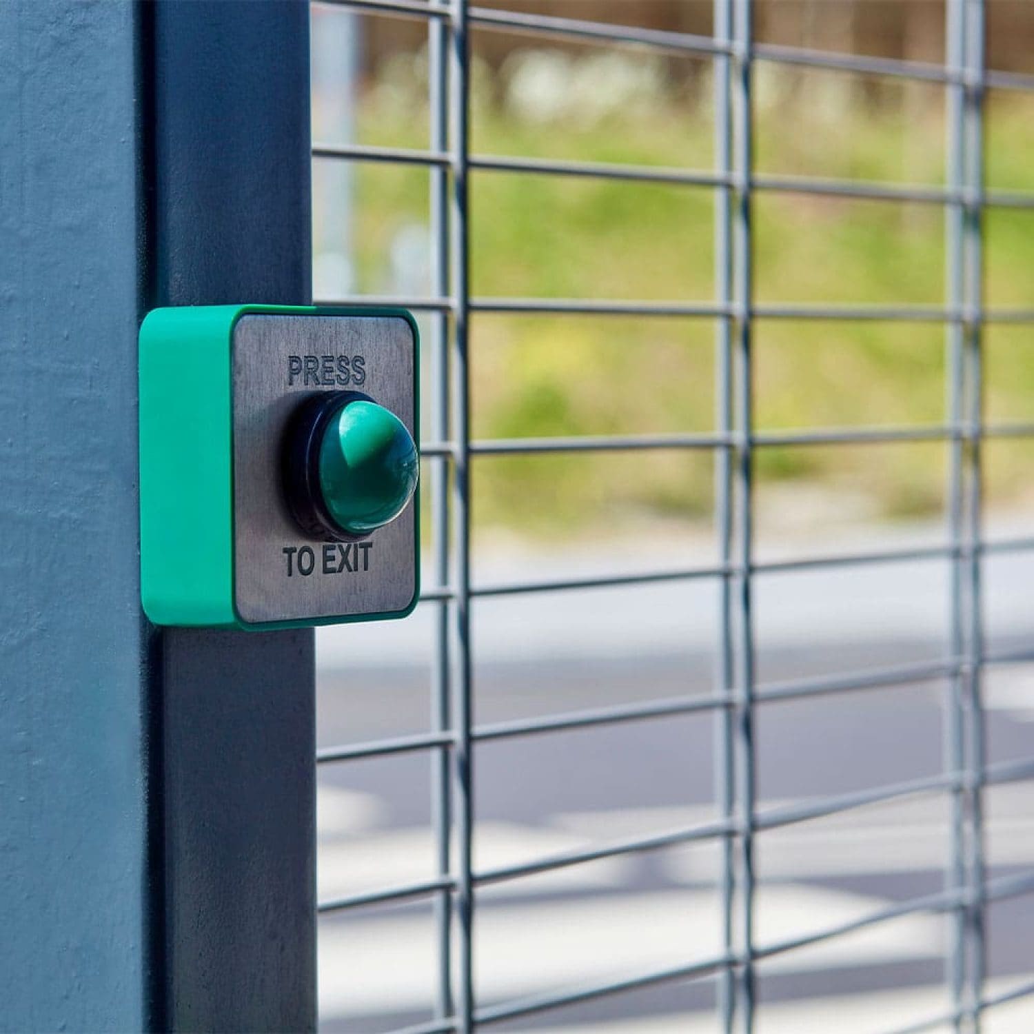a green exit button on a blue wall