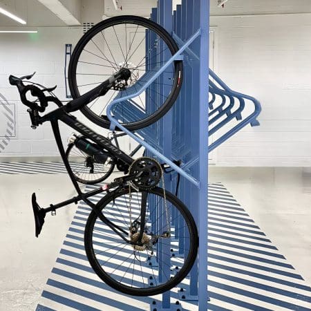 Premium Solo Vertical Bike Rack in RAL colour blue with a bike securely hung