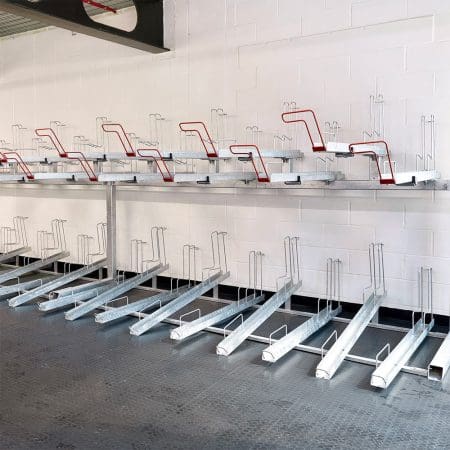A row of Two Tier Cycle Racks inside of a commercial building