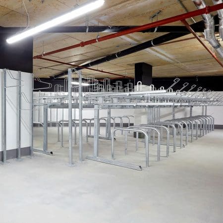 row of Two Tier Cycle Racks inside of a commercial building