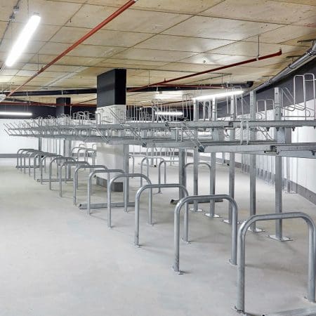row of Two Tier Cycle Racks inside of a commercial building