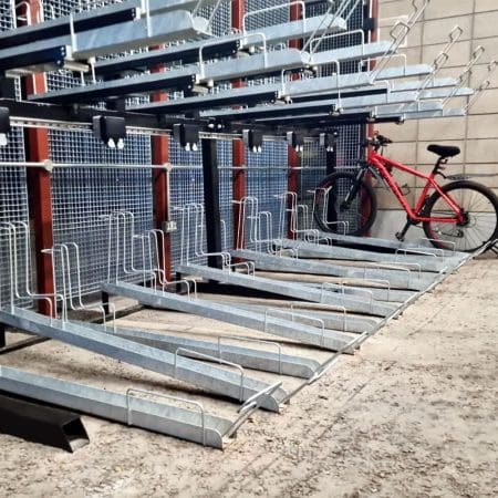 Two Tier E-Bike Racks installed in an out door bike shelter