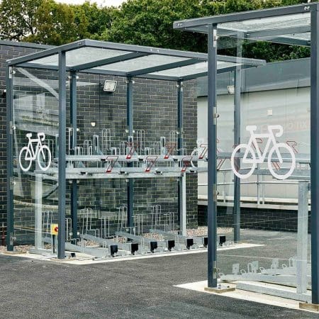 Two Tier E-Bike Racks installed in an outdoor bike shelter with cycle motif