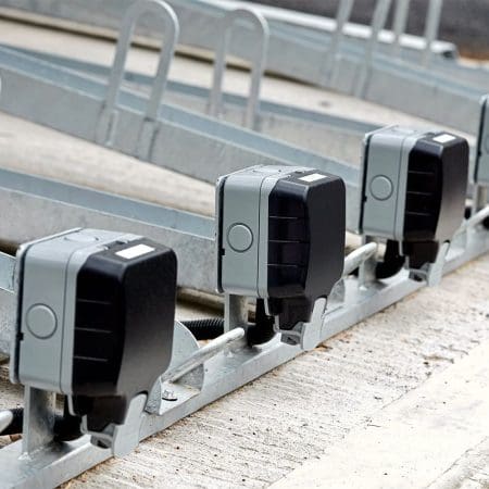 Two Tier E-Bike Racks installed in an out door bike shelter