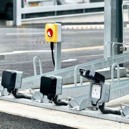 Two Tier E-Bike Racks installed in an out door bike shelter