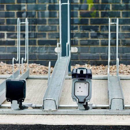 Two Tier E-Bike Racks installed in an out door bike shelter