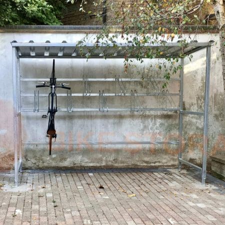 bike shelter outside with a bike hanging vertically