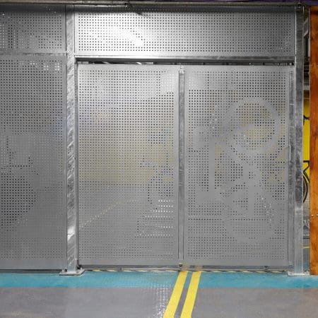 Perforated Mesh Fencing with a Bike Motif on the mesh swing door installed in an underground cycle storage facility