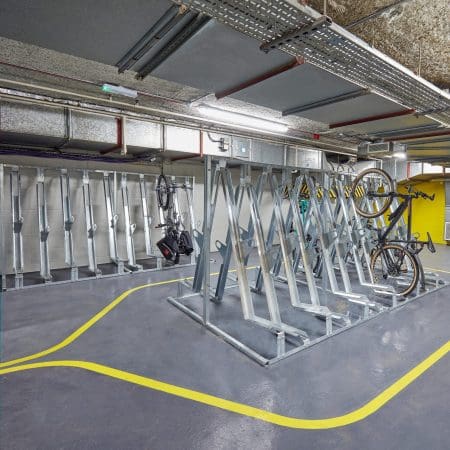 Many Semi Vertical Bike Racks installed in an underground cycle storage facility