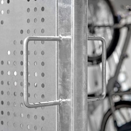Close up of the perforated mesh swing door installed in the underground cycle storage facility